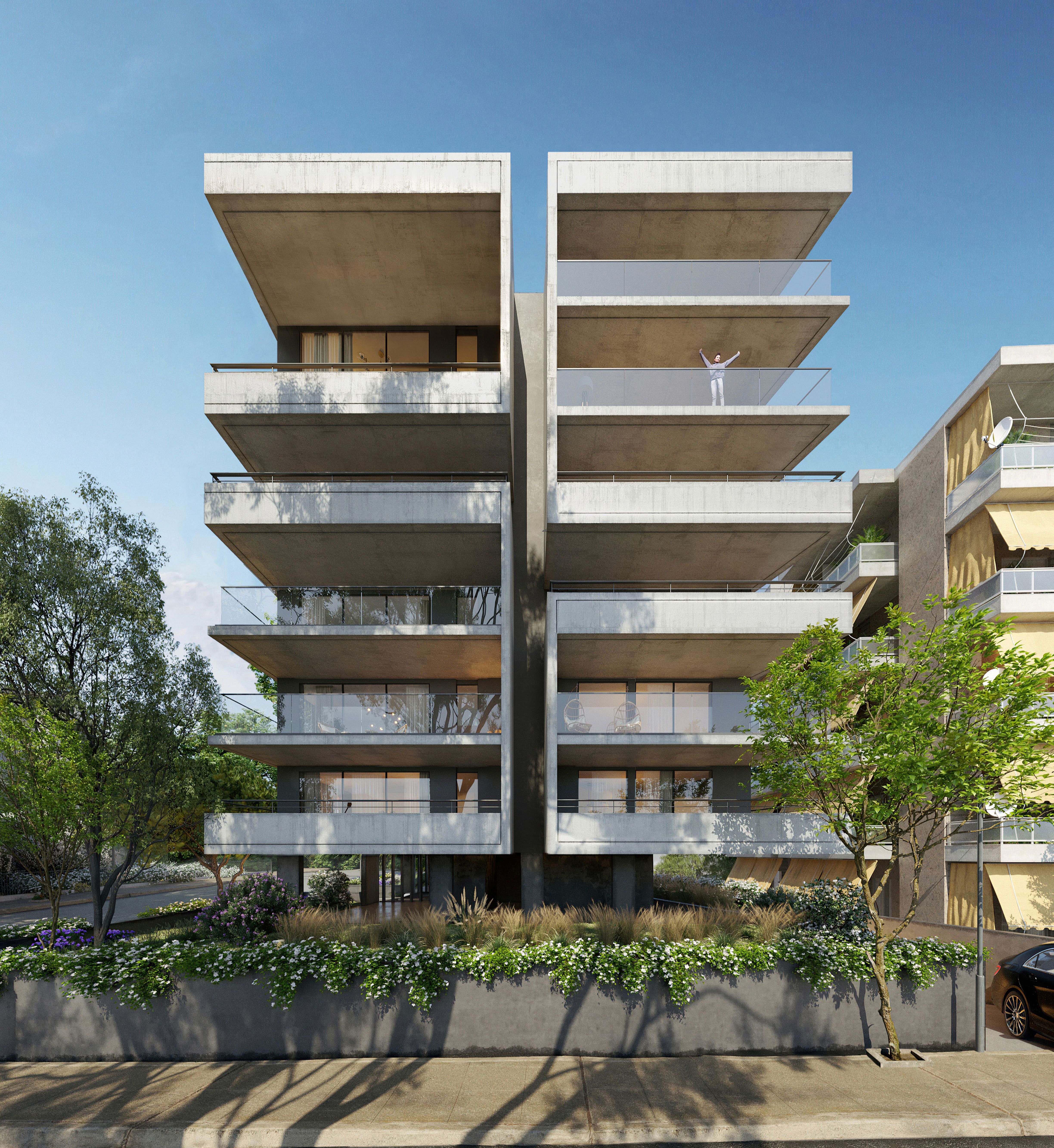 Modern concrete apartment building with multiple balconies and glass railings, surrounded by green trees.
