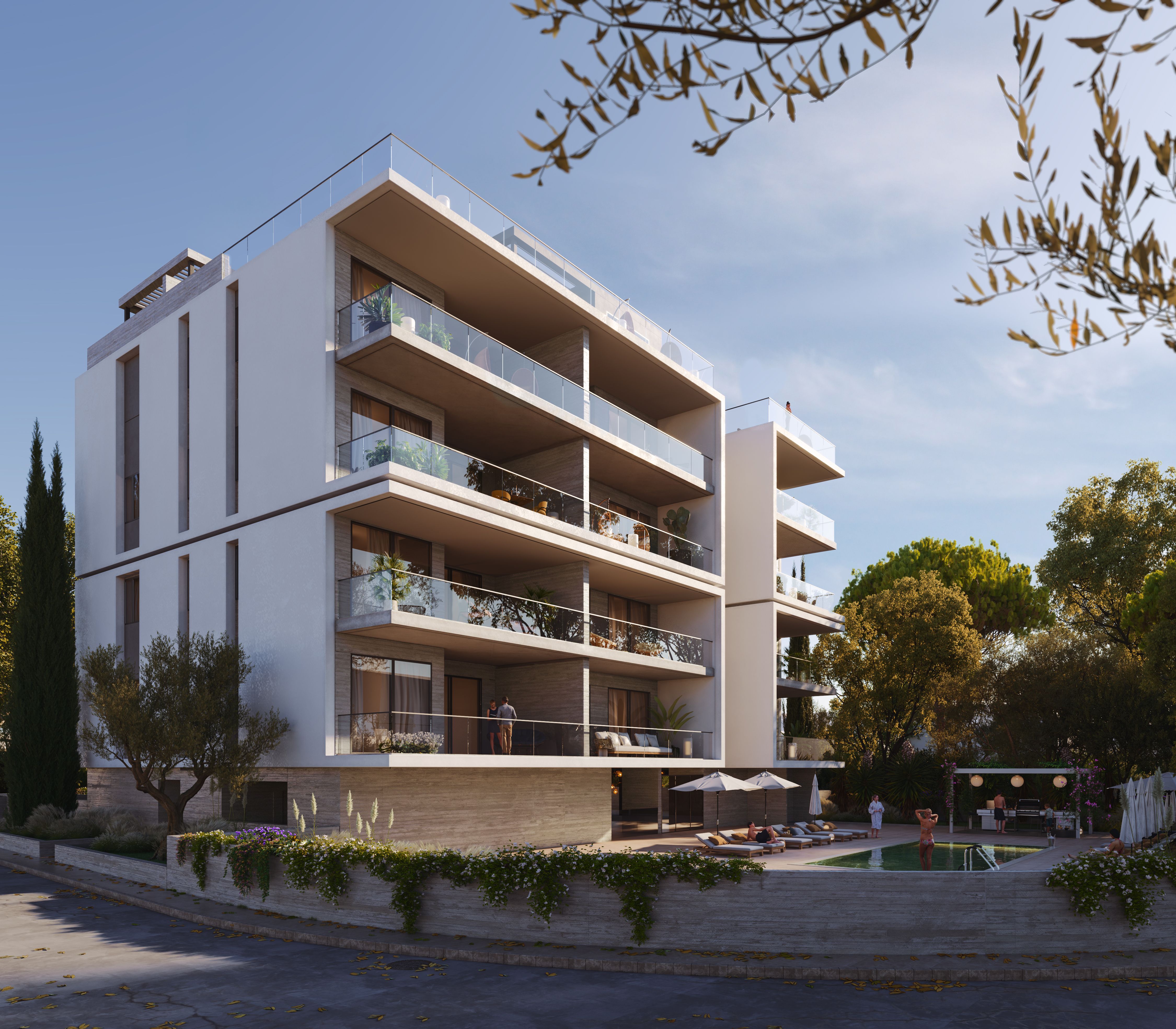 Modern white apartment building with glass balconies surrounded by green trees under a blue sky.