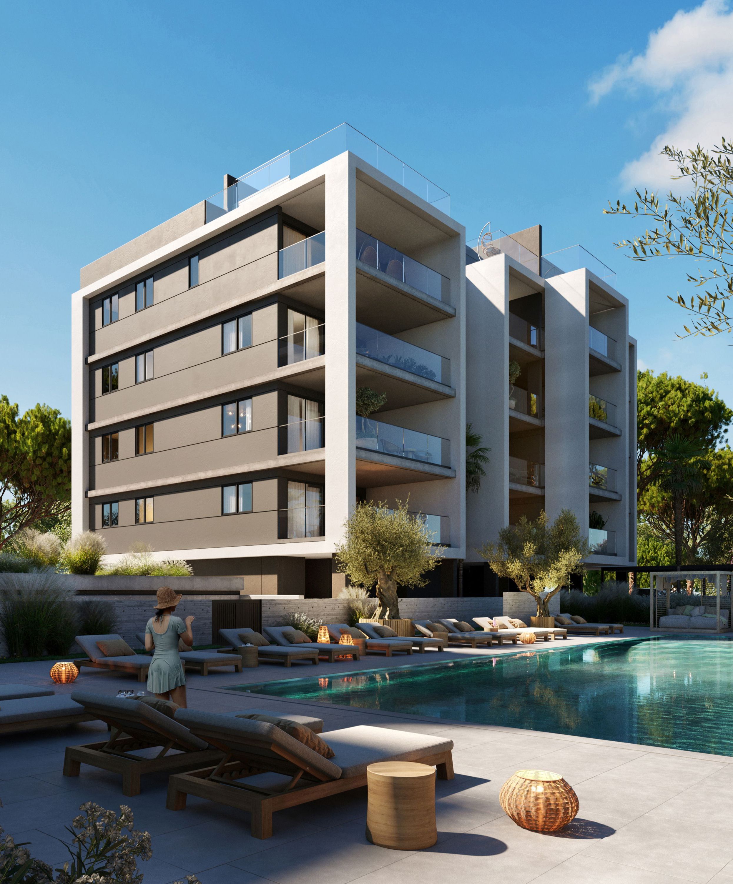 Modern apartment building with multiple balconies overlooking a clear swimming pool and lounge chairs.