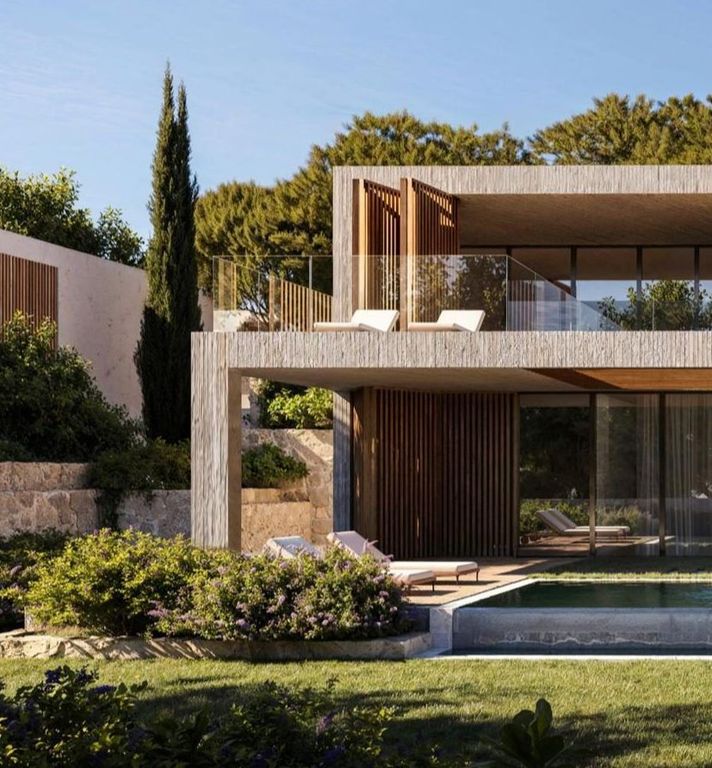 Modern multi-level concrete and glass villa with an outdoor pool surrounded by lush green landscaping.