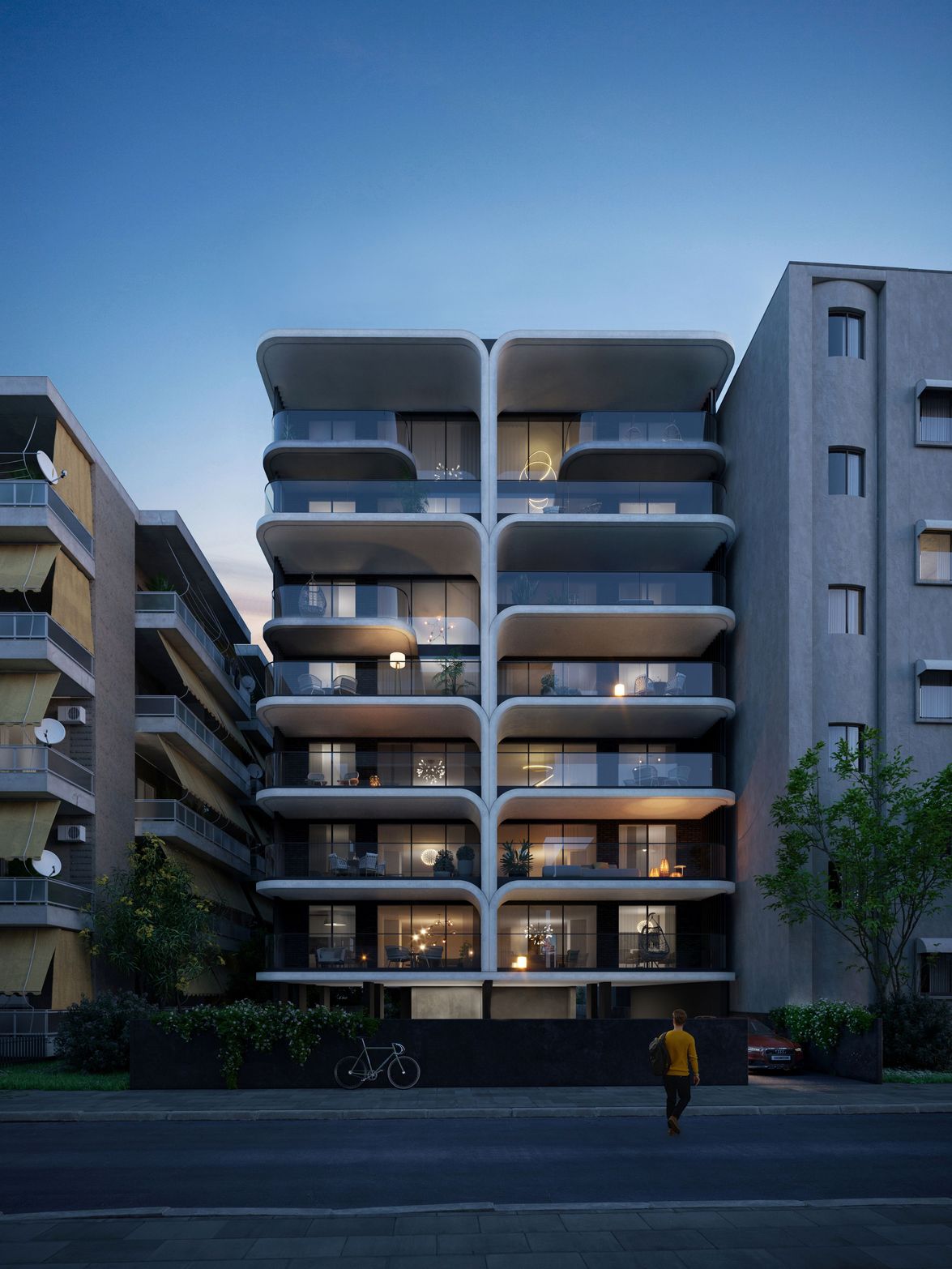 Modern multi-story apartment building with curved balconies illuminated at dusk, next to other structures.