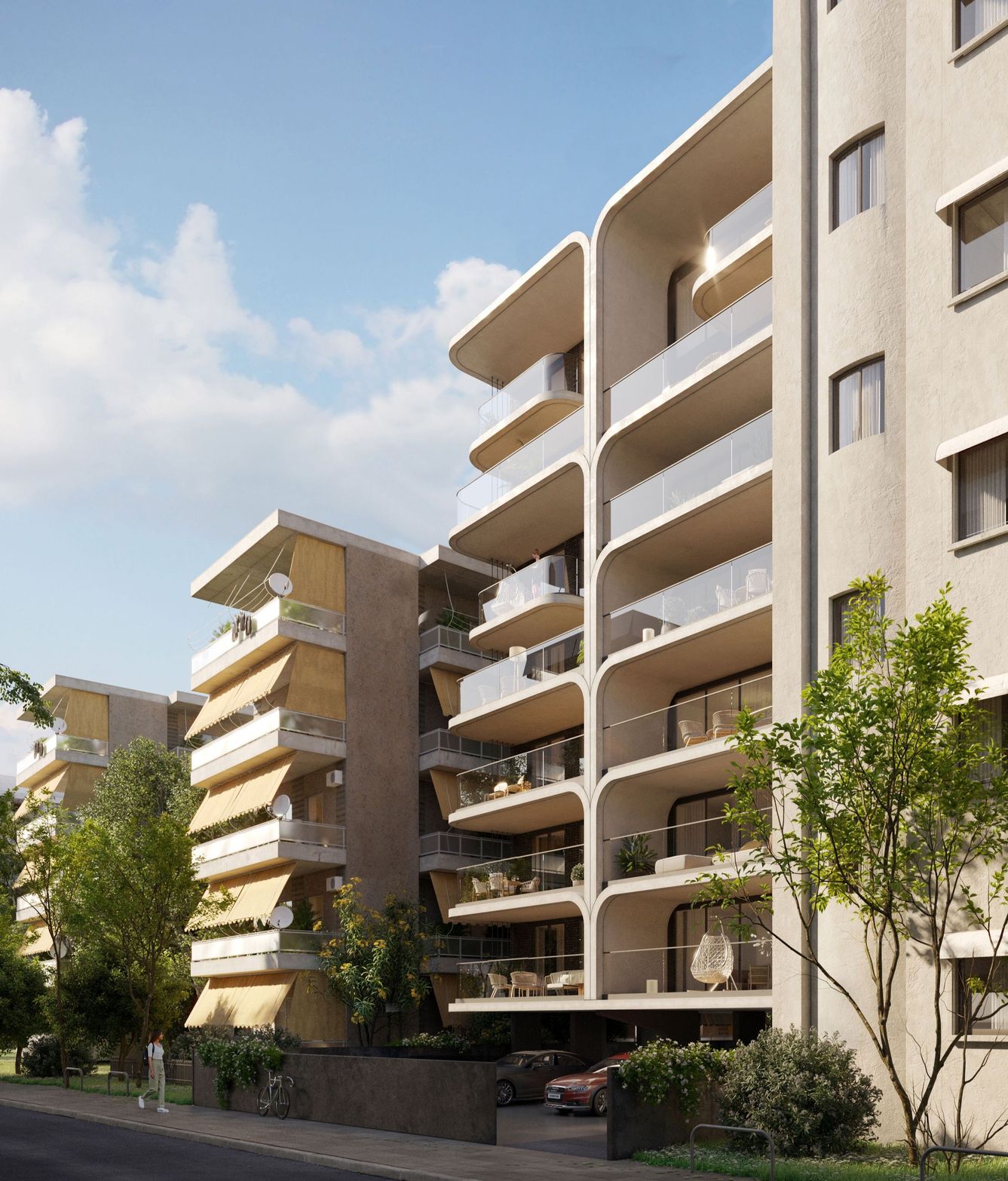 Modern multi-story apartment building with balconies and green trees under a clear blue sky.