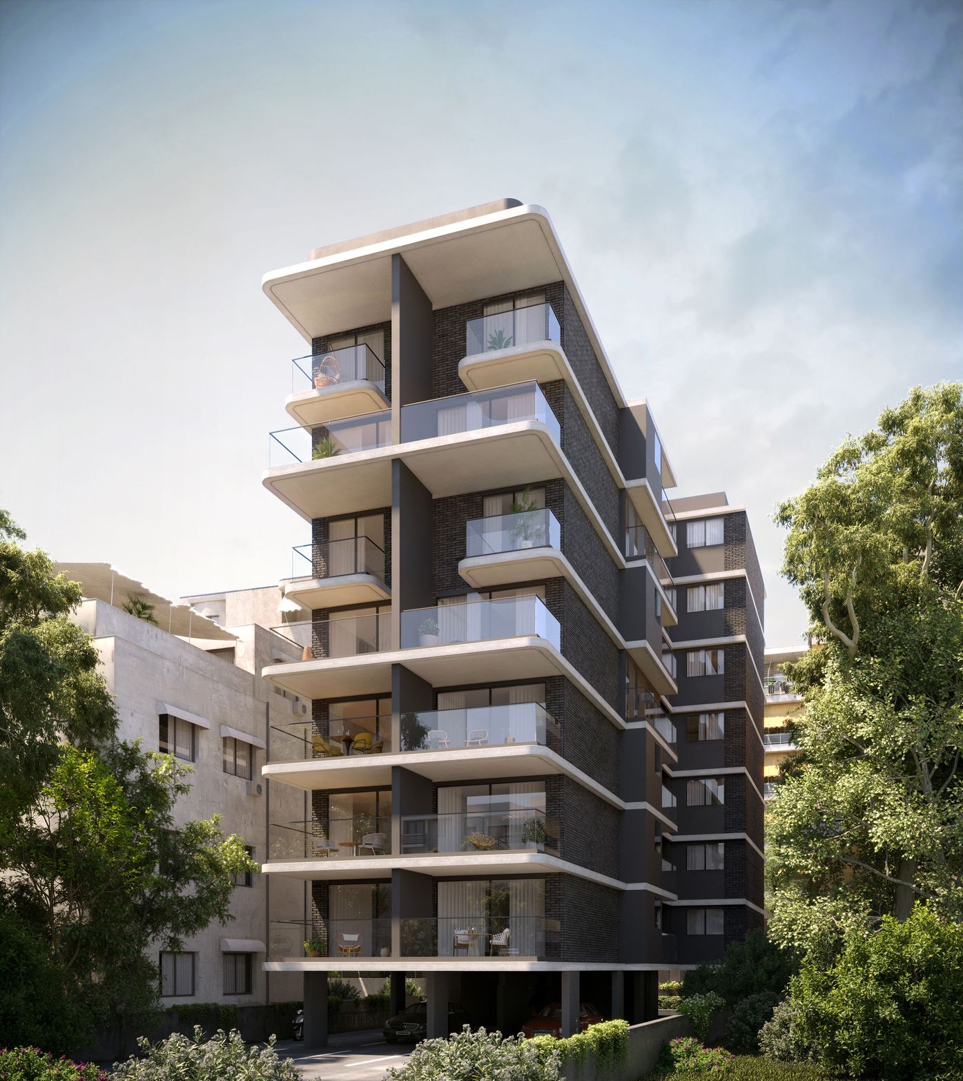 Modern multi-story apartment building with dark facade and white balconies, surrounded by green trees.