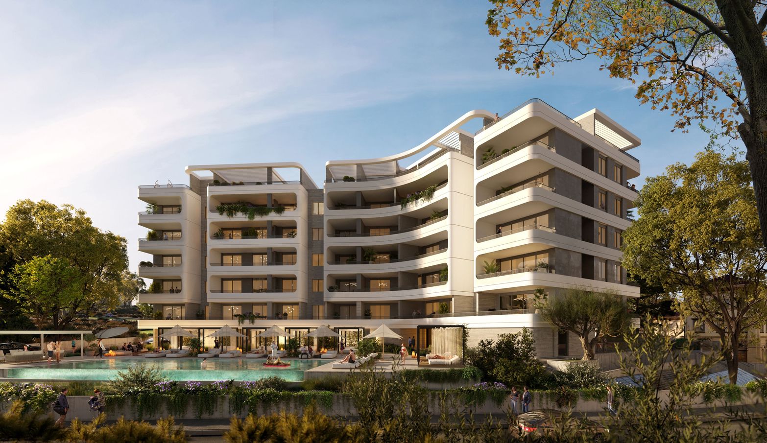 Modern hotel building with white facade, balconies, and a swimming pool surrounded by trees.