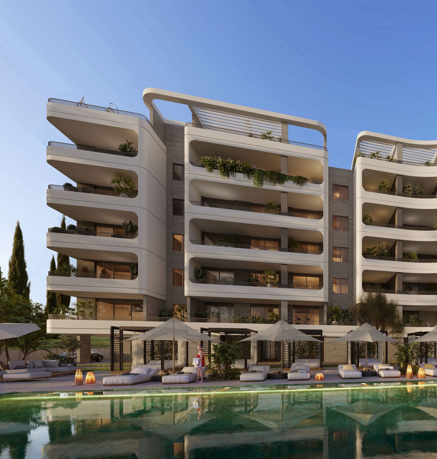 Modern apartment building with sleek, curved balconies overlooking a serene swimming pool.