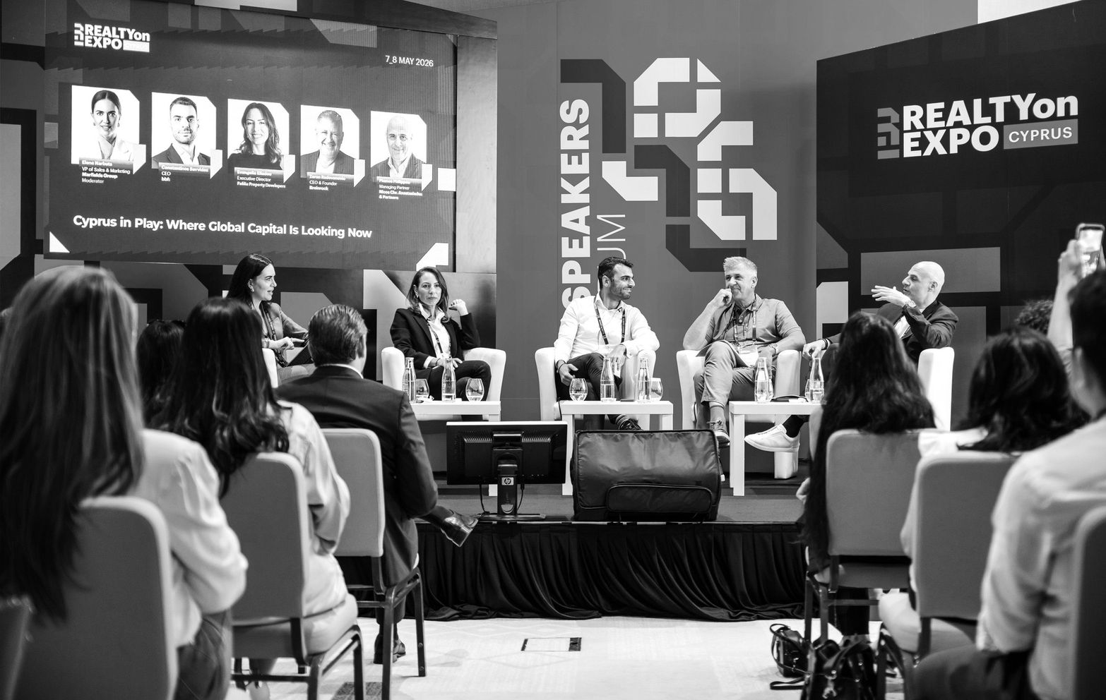 Panel discussion at RealtyOn Expo with industry speakers on stage and an attentive audience.