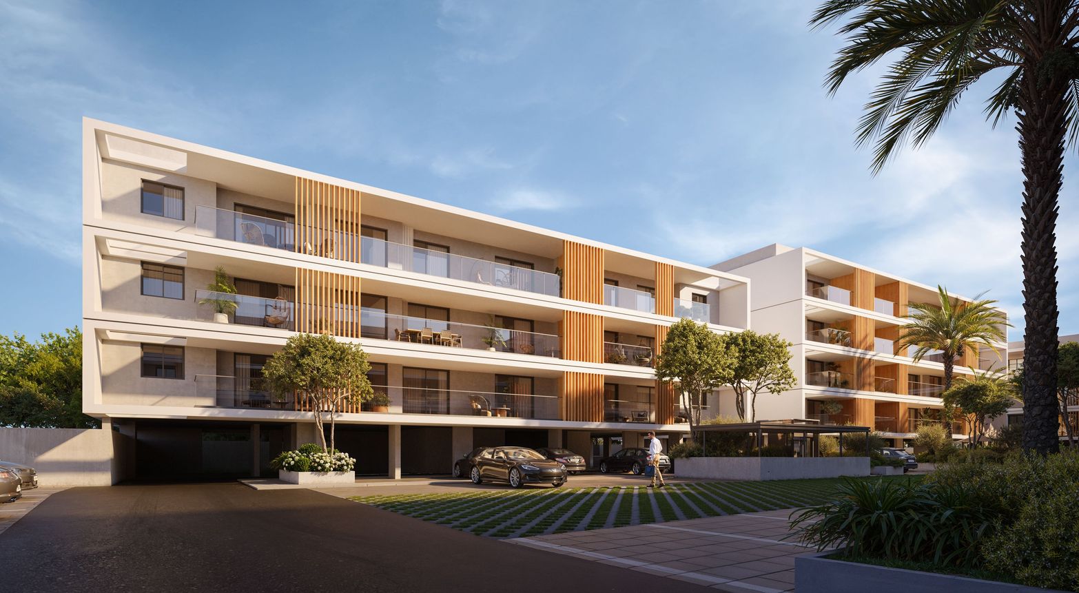 Modern apartment building with white and wood facades, balconies, and palm trees under a blue sky.