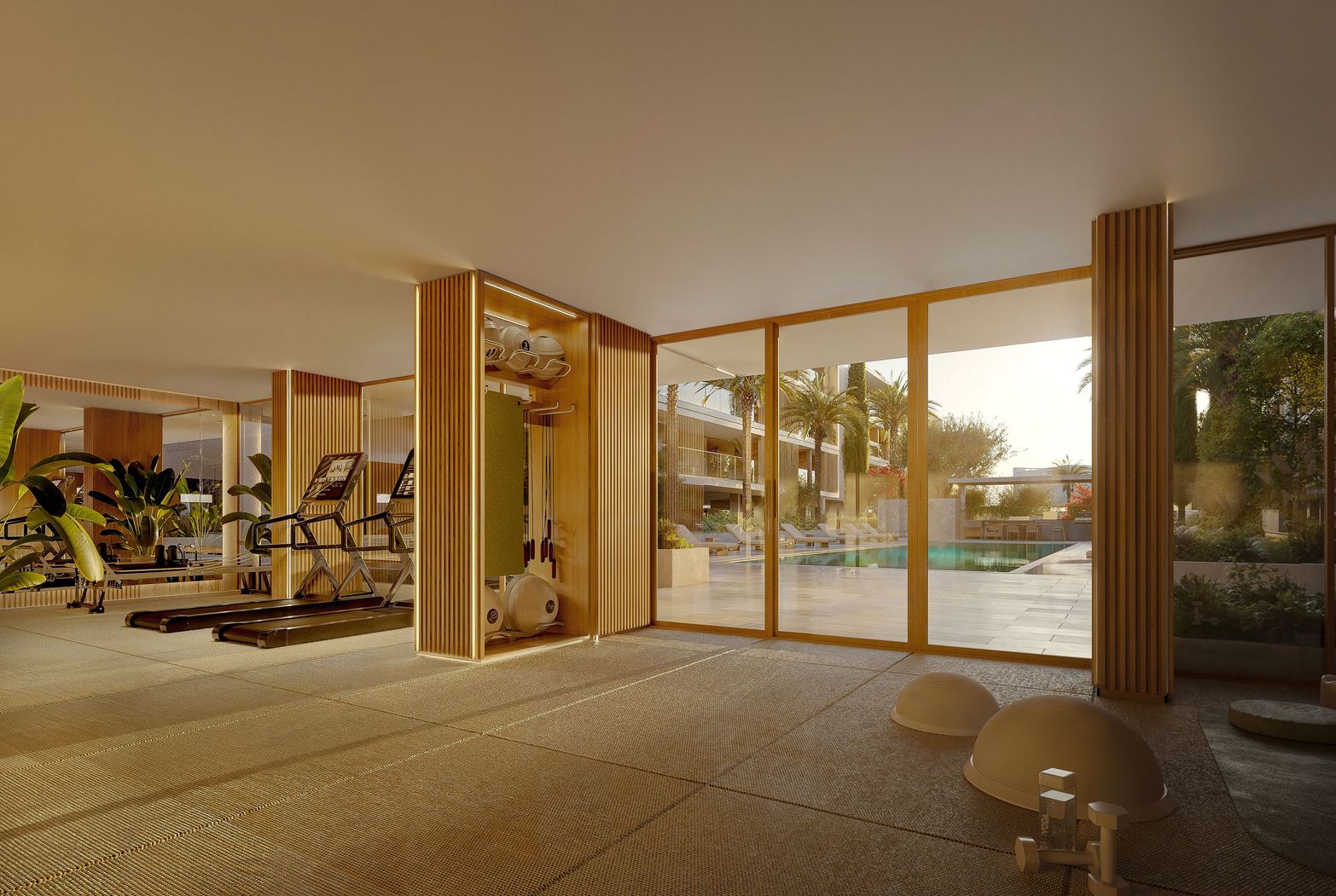 Modern indoor gym featuring exercise equipment and large windows overlooking a sunlit outdoor pool.