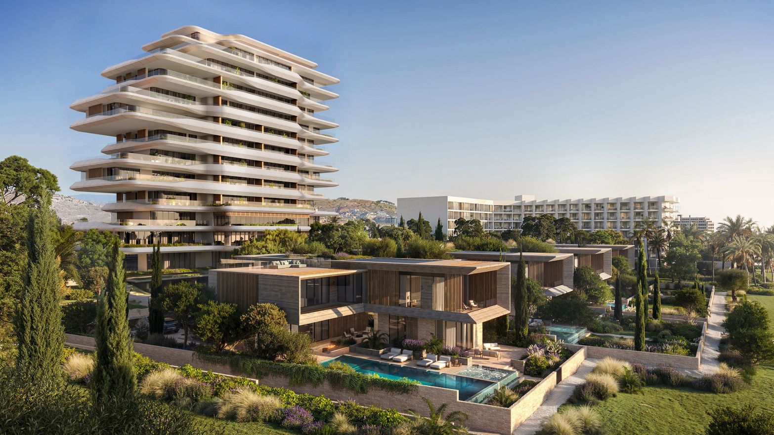 Modern high-rise building and luxury villas with swimming pools amidst lush greenery.