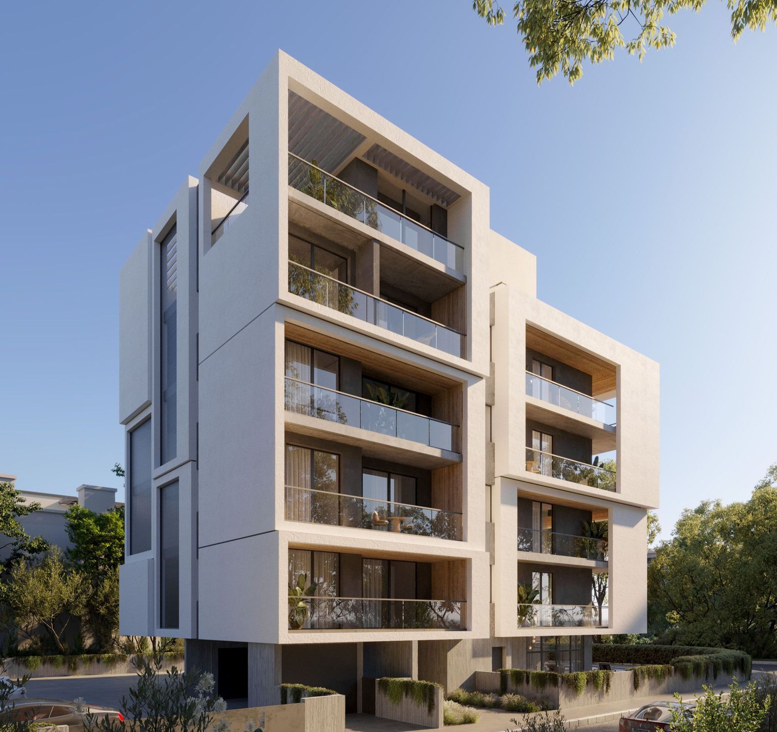 Modern white apartment building with multiple balconies and large windows under a clear sky.