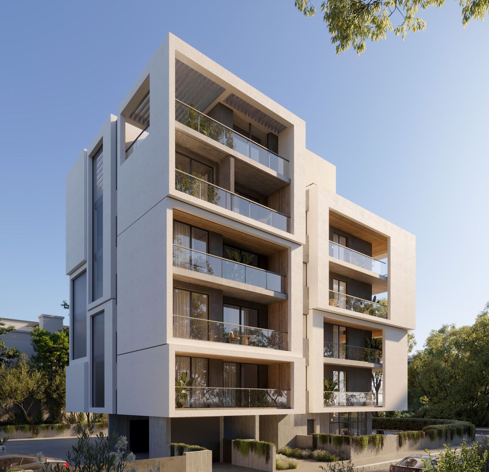 A modern, light-colored apartment building with glass balconies and contemporary geometric design.