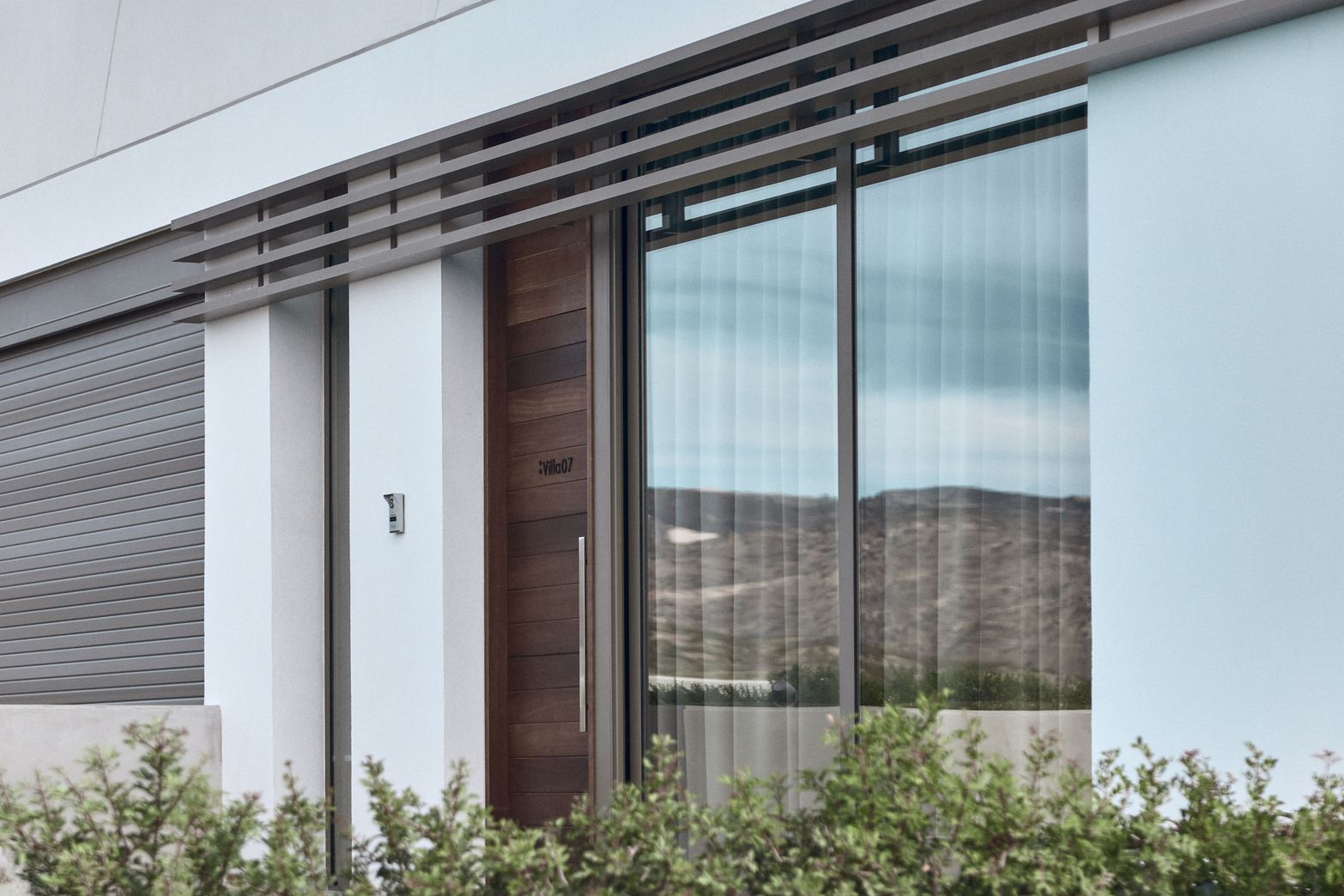 Modern building exterior with dark wooden door, glass windows, and number 78.