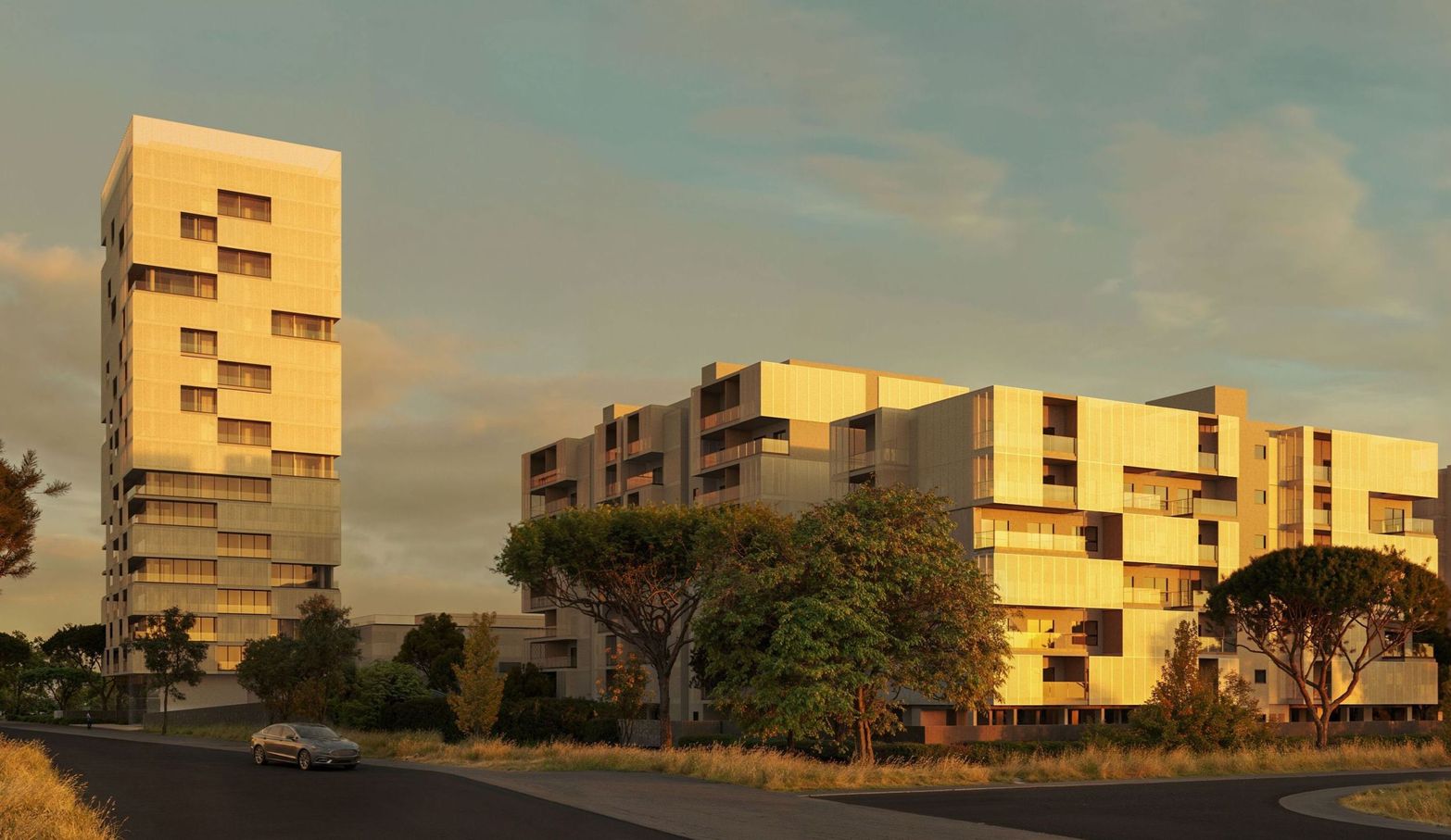 Modern tall and low buildings with unique architecture under a clear sky at sunset or sunrise.