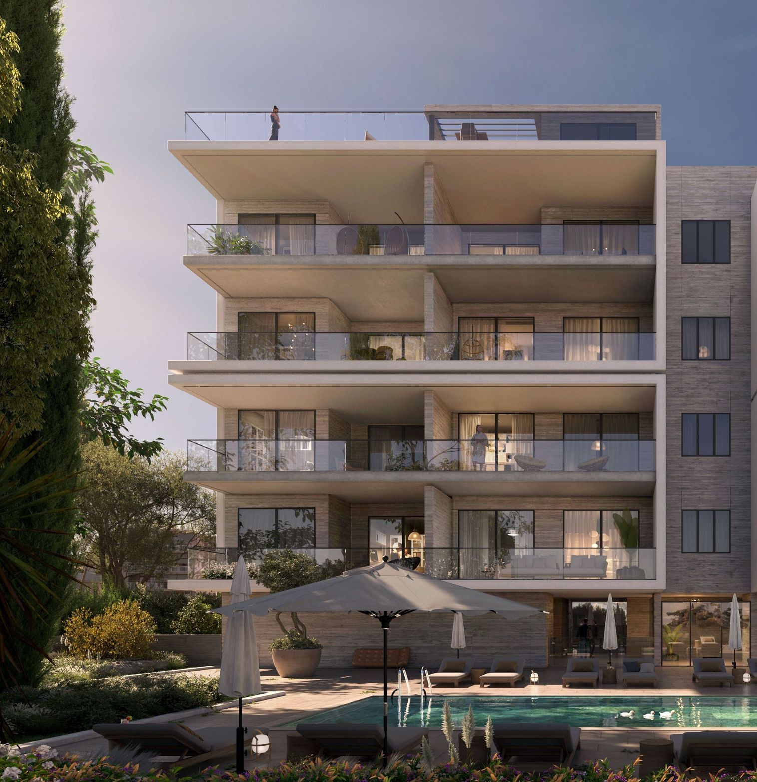 Modern apartment building with balconies overlooking a swimming pool and lush green landscaping.