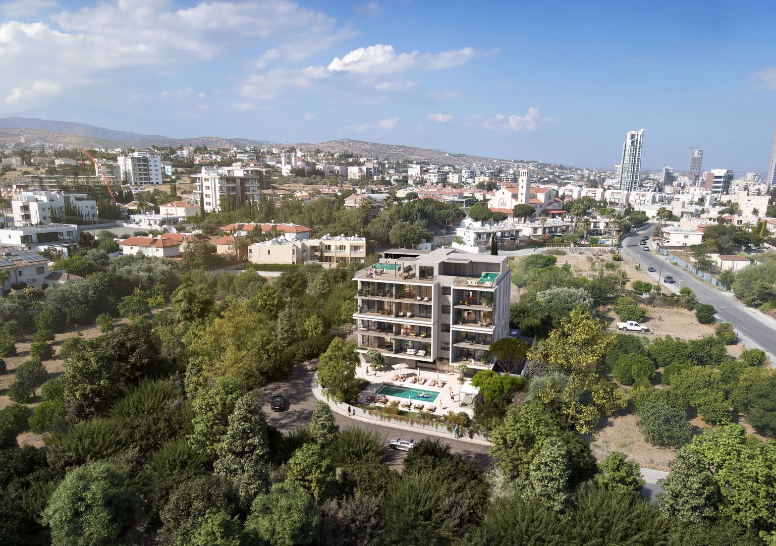 Aerial view of a modern apartment building with a pool surrounded by trees and a city.