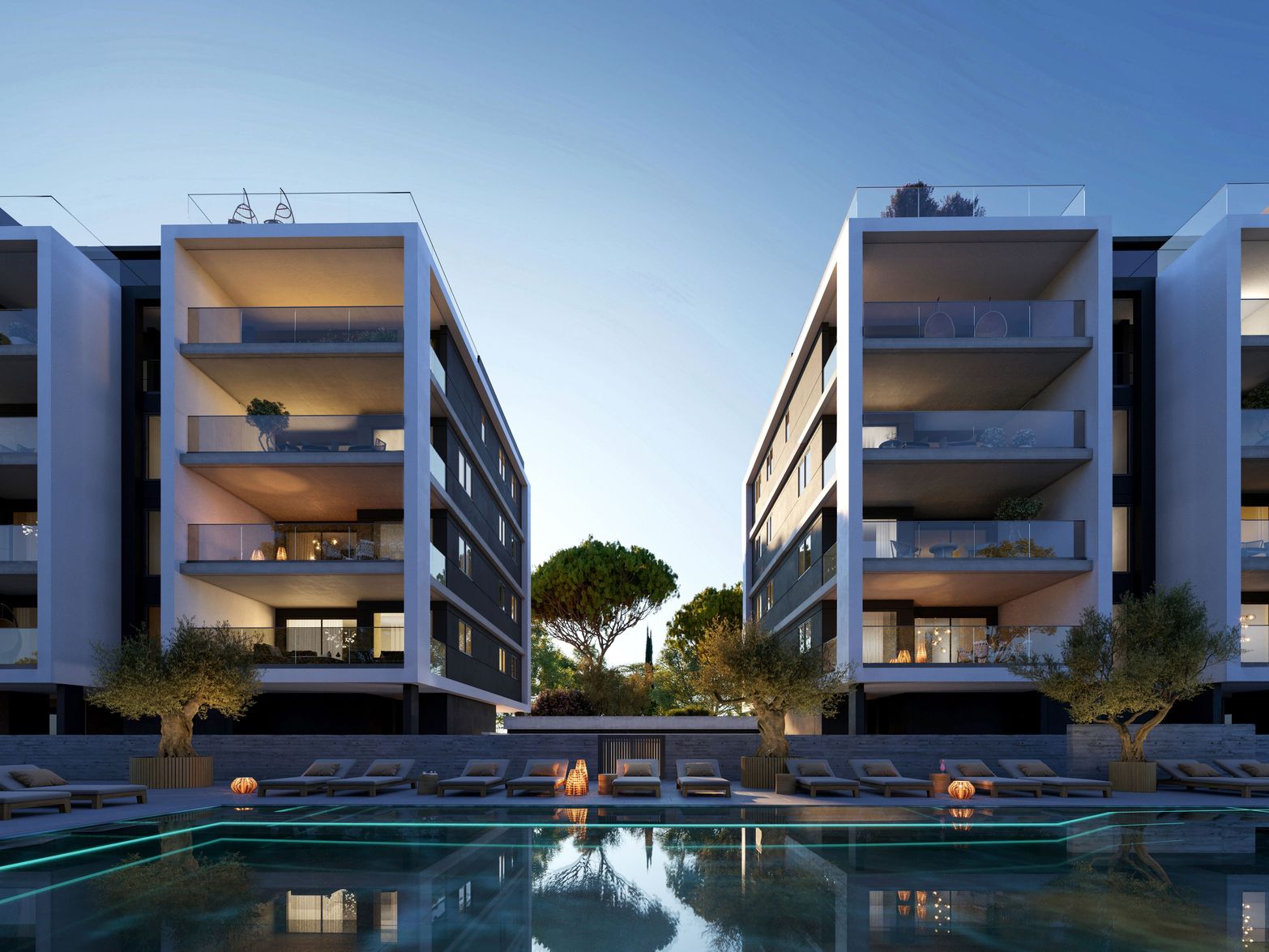 Two modern apartment buildings with balconies flank a swimming pool and central tree.