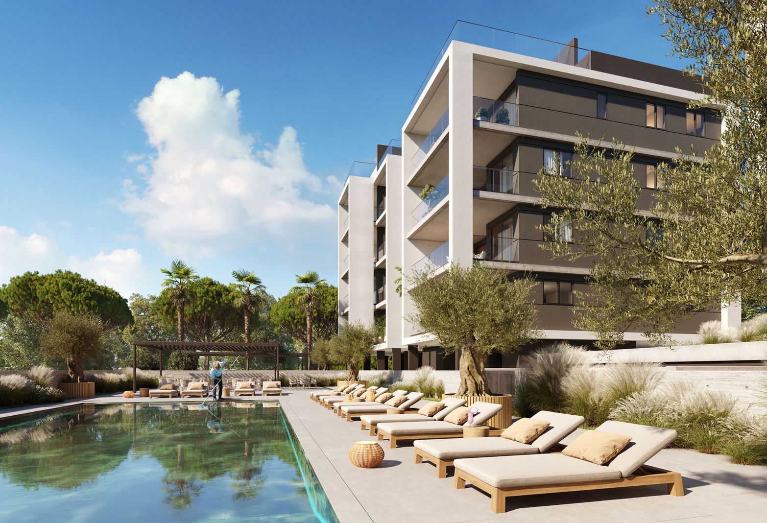 Modern apartment building with a swimming pool and lounge chairs under a clear blue sky.
