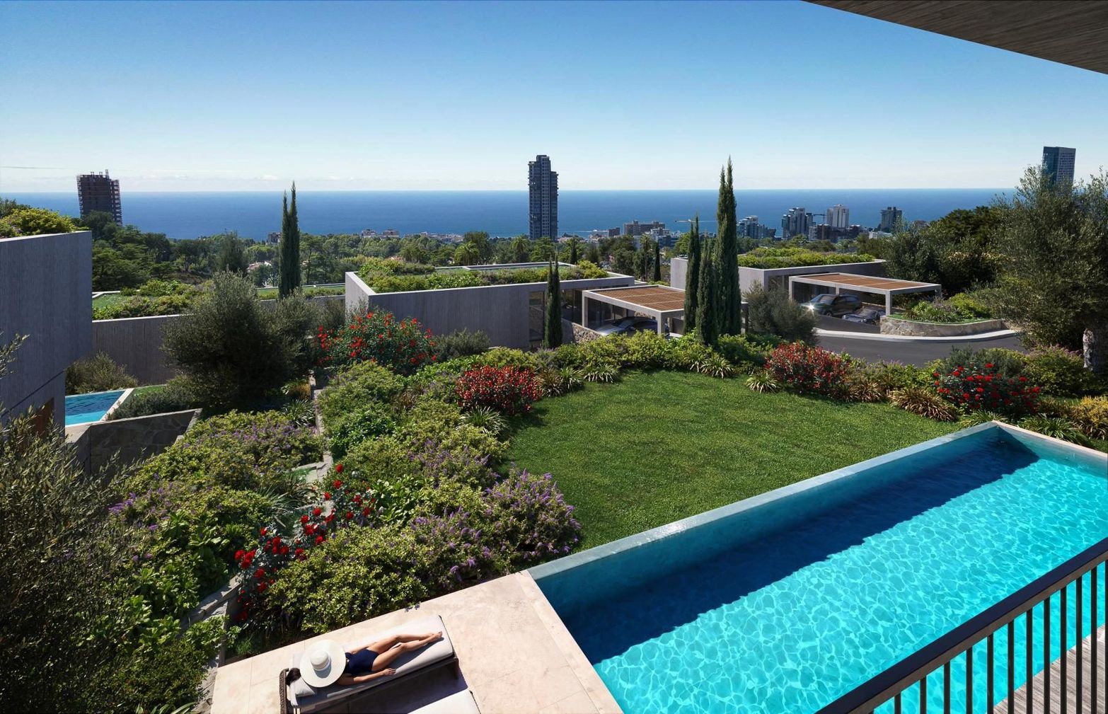Luxury infinity pool with clear blue water overlooking a lush garden and the expansive sea.